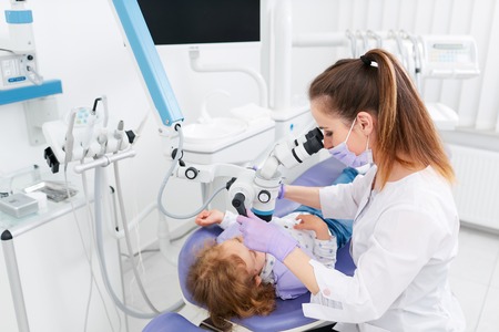 Woman making cure for little girlの写真素材