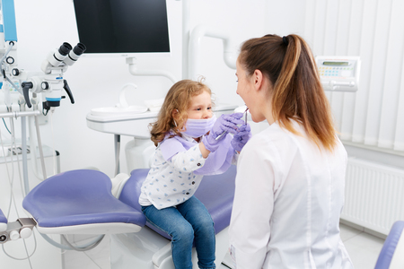 Little girl playing with dentistの写真素材