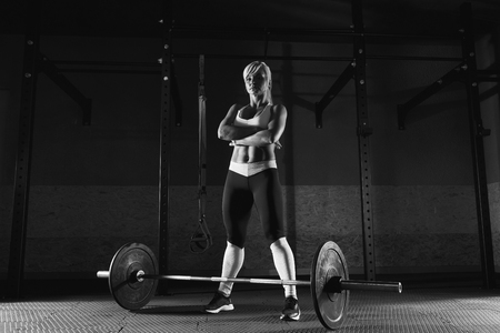 Young fitness girl is standing in the gymの写真素材