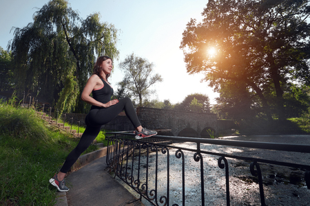 Girl stretching in beautiful parkの写真素材
