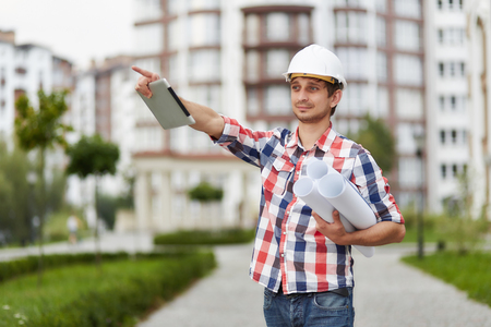 Young architect in front of apartment buildingの写真素材