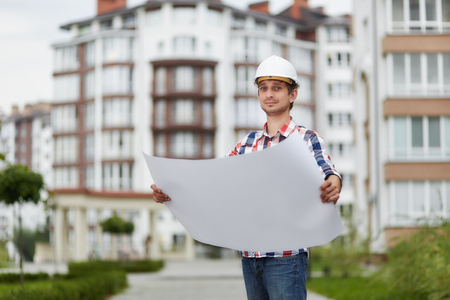 Young architect in front of apartment buildingの写真素材