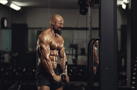 Mature sportsman exercising at the gymの写真素材