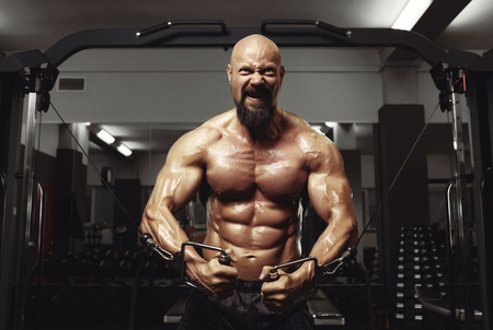 Mature sportsman exercising at the gymの写真素材