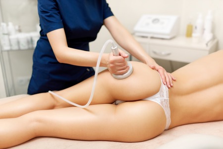 Hardware cosmetology. Young woman getting rf lifting procedure in a beauty parlour.の写真素材