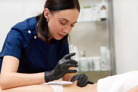 Woman having lifting injection in abdomen in beauty clinic.の写真素材
