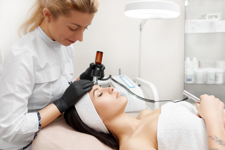 Cosmetologist doing rf lifting in modern beauty salon.の写真素材