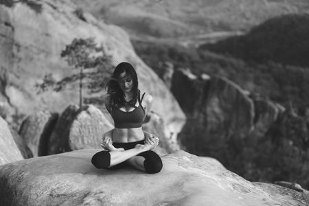 Young woman practicing yoga outdoorsの写真素材
