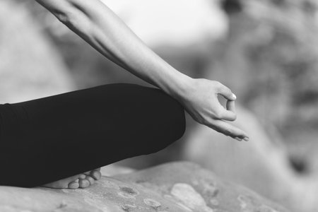 Young woman practicing yoga outdoorsの写真素材