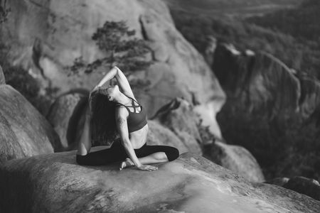 Young woman practicing yoga outdoorsの写真素材