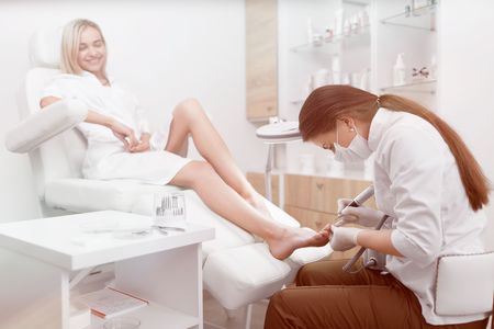 Podiatrist making procedure for smiling clients foot.の写真素材
