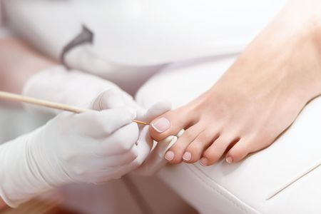 Specialist in beauty salon making french pedicure for female cliの写真素材