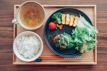 Japanese set meal, hambagu steak with egg and saladの写真素材