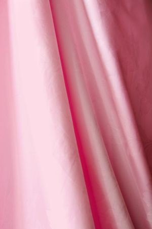hanging pink satin fabric with foldsの写真素材