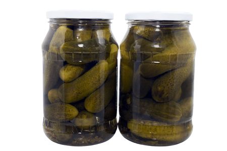 two jars of pickled cucumbers isolated on a white backgroundの写真素材