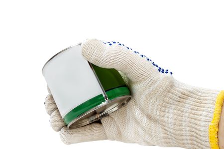 metal tin in his hand in a glove isolated on white backgroundの写真素材