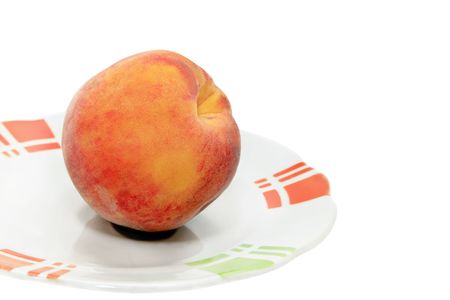 peach on a plate isolated on a white backgroundの写真素材