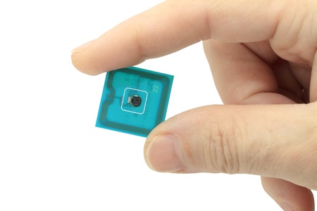 the computer electronic chip in the thumbの写真素材