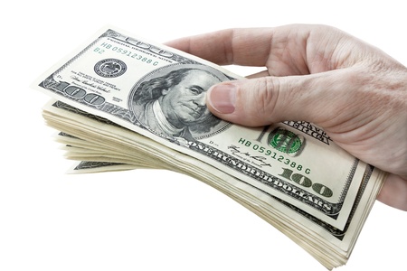 hundred dollar bills in hand isolated on white backgroundの写真素材