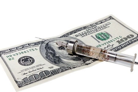 money and syringe isolated on white backgroundの写真素材