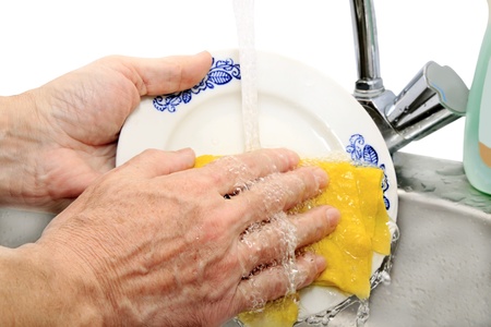 hand wash dishes under running waterの写真素材