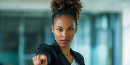 A woman in a business suit is pointing to something.の素材