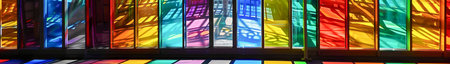 A colorful display of glass panels with a rainbow of colors.の素材