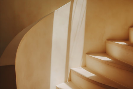 Sunlit Spiral Staircase with Gentle Shadows in a Minimalist Interior.の素材
