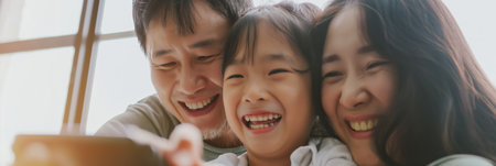 Happy Asian Family Enjoying Quality Time Together with Smiles and Laughter.の素材