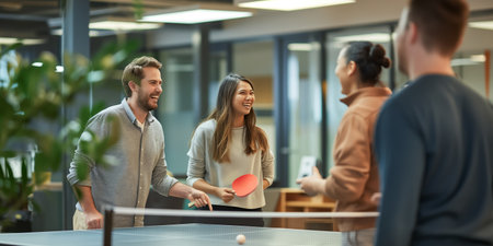 Friendly MixedGender Office Team Enjoying a Ping Pong Game Together.の素材