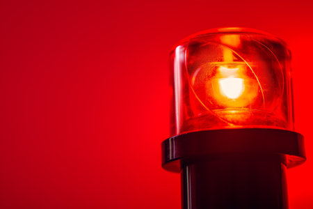 Emergency Red Flashing Light Signal Warning, Alert, Attention Isolated on Red Background.の素材