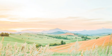 Serene Sunset Over Rolling Hills with Lush Greenery and Soft Pastel Sky.の素材