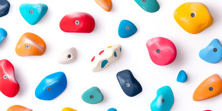 Colorful Climbing Holds Arranged on a Bright White Surface for Training and Recreation.の素材