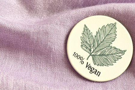 Vegan Badge on Purple Fabric EcoFriendly Symbol of PlantBased Lifestyle.の素材