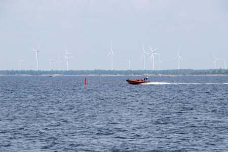 Coast guard boat passing wind turbines at Henvey Inlet in the Parry Sound District on Georgian Bay