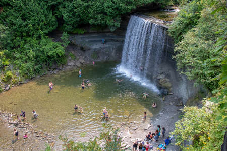 Bridal Veil Falls, Ontario, Canada - August 3, 2021: People enjoying the cool freshwater at Bridal Veil Falls on a summer day on Manitoulin Islandのeditorial素材