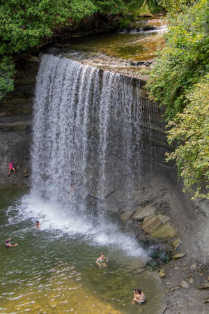 Bridal Veil Falls, Ontario, Canada - August 3, 2021: People enjoying the cool freshwater at Bridal Veil Falls on a summer day on Manitoulin Islandのeditorial素材