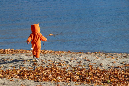 Osoyoos, British Columbia, Canada - October 31, 2021: A kid dressed up for Halloween on the beachのeditorial素材