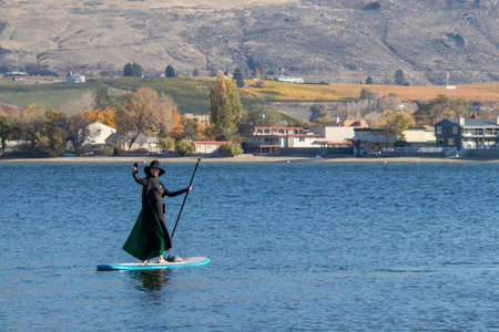 Osoyoos, British Columbia, Canada - October 31, 2021: A woman dressed up for Halloween taking a selfie at the Witches on The Water event in the Okanagan Valleyのeditorial素材