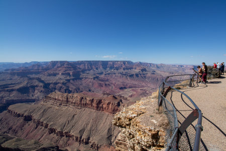 Grand Canyon National Park, Arizona - April 1, 2022 : Tourists read the plaques at the edge of the...
