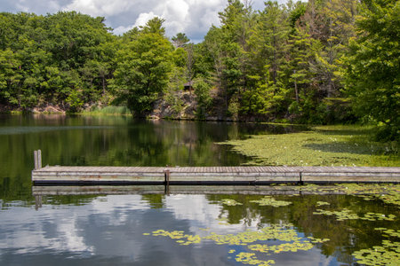 summer at a boat dock on a calm lake in Ontario, Canadaの写真素材