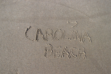 Carolina Beach written in the sand on a sunny day at the beachの写真素材