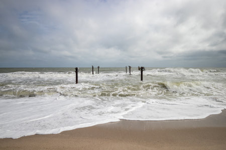 Atlantic Ocean in stormy weather, waves and wooden breakwatersの写真素材
