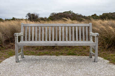 empty park bench beside the sand dunes on the Atlantic Coast