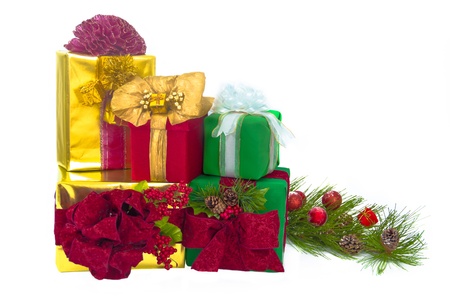 A gold foil-wrapped gift topped by a red damask bow, a green-wrapped gift topped by a red damask bow, a red damask gift topped by gold paper ribbons and bow, a gold-foil-wrapped gift with a red curly bow and a green-wrapped gift with a white bow are stackの写真素材