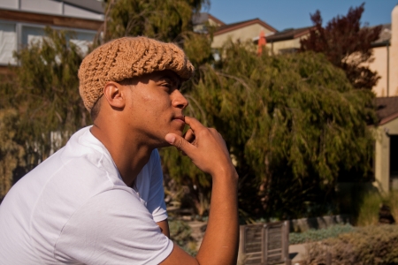 A young man in a knit pose looks thoughtful.の写真素材