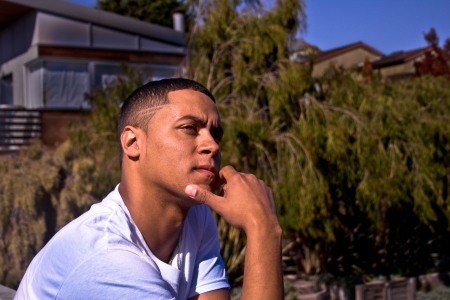 A young man is in a thoughtful pose.の写真素材