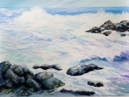 Foamy surf splashes over a rocky beach の写真素材