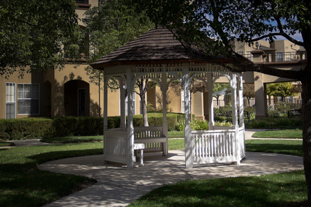 A white gazebo offers a shady place to sit.の写真素材
