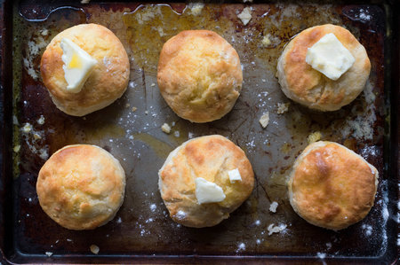 Country Biscuits with butter in rustic setting top view